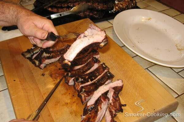 Smoky Apple Butter Pork Ribs On Cutting Board, And a Tempting Rib On Fork