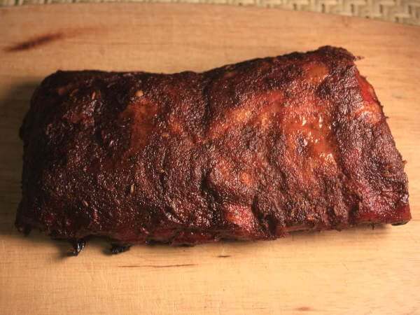 Smoked Slab of Pork Ribs On a Bamboo Cutting Board Smoked Half Slab of Babybacks On Cutting Board