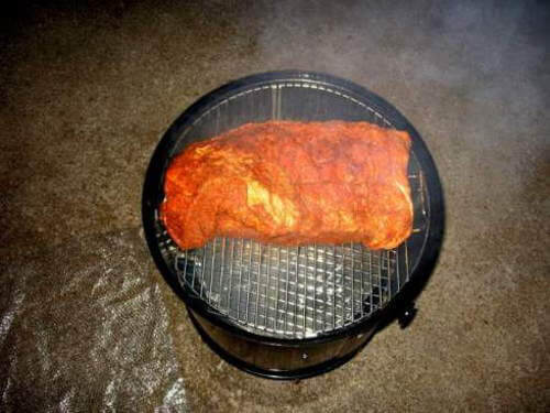 A well seasoned whole brisket on the top grate of a Weber Smoky Mountain Smoker.