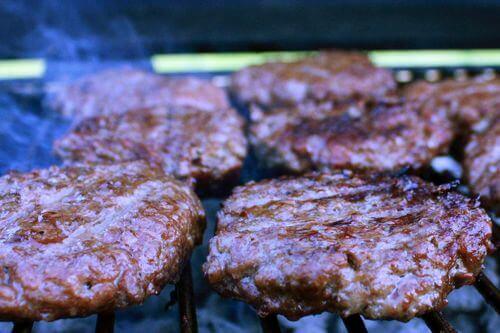 Hamburgers Being Grill-Smoked, Ready For Their Much Needed Slices Of Cheddar Cheese