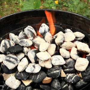 Fire Ring In Weber Smoker Filled With Burning Charcoal and Smoker Wood