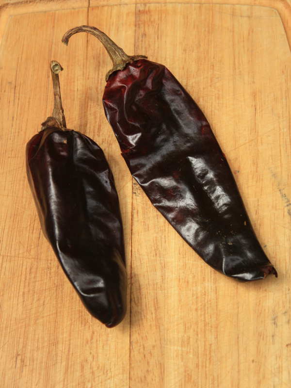 Dried New Mexico Chile Pods On Cutting Board