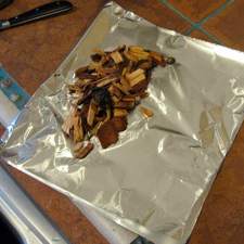 Wrapping Woodchips in Foil, Making Smoker Wood Packets for Grill Smoking Wrapping Smoker Wood Chips In Aluminum Foil and Used For Grill Smoking a Turkey
