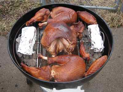 Turkey Cut Into Sections, Cooking On a Grill Sections of a Whole Turkey Cooking on a Grill