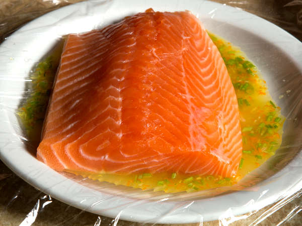 Beautiful Fillet of Salmon, Soaking In a Flavorful Marinade Marinating a Salmon Fillet In a White Bowl