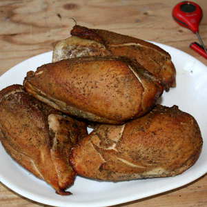 Smoked Chicken Breasts On a White Platter. These Breasts Reached the Safe Internal Temperature of 165°F.