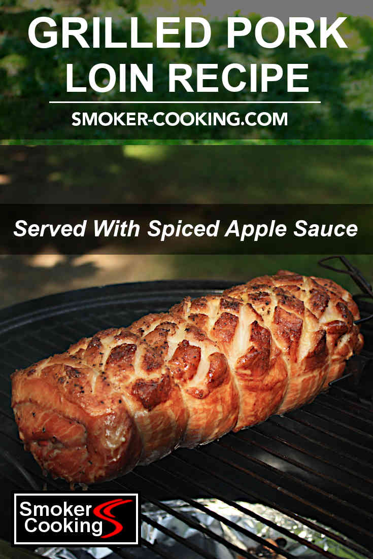 A beautiful golden brown grilled pork loin, the fat scored in a criss-cross pattern on the top.