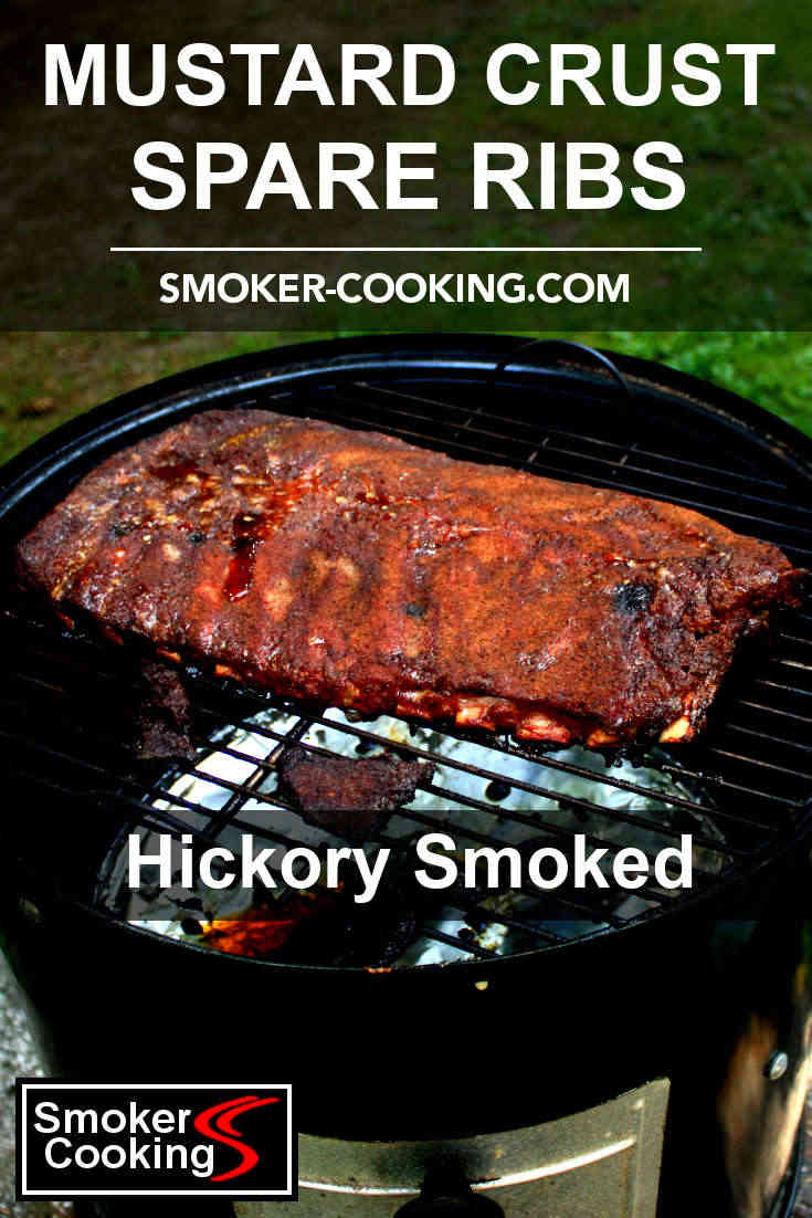 A slab of spareribs seasoned with a mustard paste and spices, resting on the top grate of a Weber smoker. pin this image