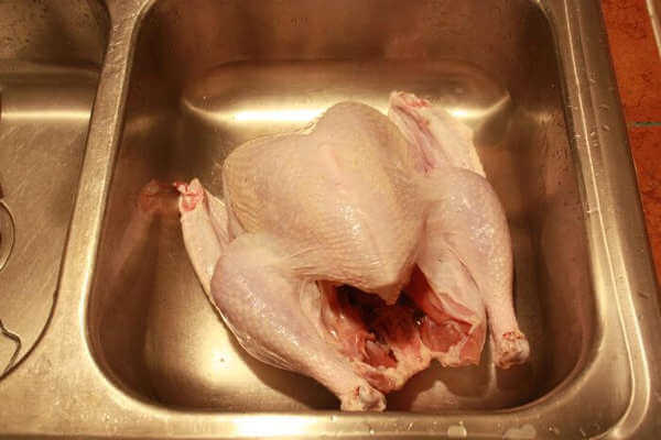 Raw Turkey and Hand With Knife, Right Before Preparation