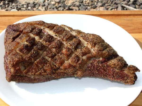 Whole Smoked Tri Tip On White Platter, Desert Rocks in Background