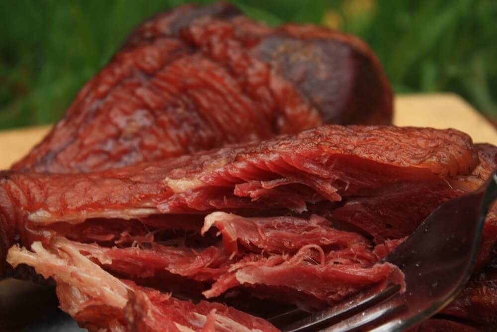 Beautifully Smoked Turkey Legs, One Partially Shredded Showing Luscious Interior