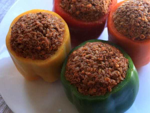 Colorful Bell Peppers, Just Stuffed With a Beef Filling, Ready To Be Put Into The Smoker Four Stuffed Bell Peppers, Filling Still Uncooked, Before Being Placed In The Smoker
