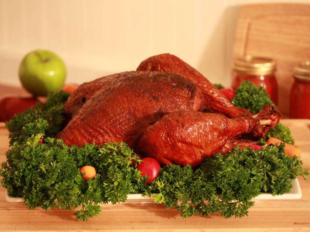 Smoked Turkey Surrounded By Fresh Parsley and Vegetables