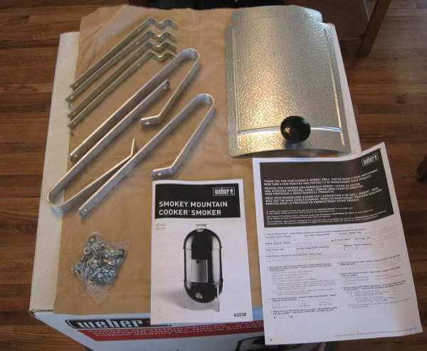 Weber Smokey Mountain Cooker Parts Displayed On Shipping Box