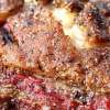 This Close Up of a Smoked Tri Tip Shows Crisped Fat and Rare Beef
